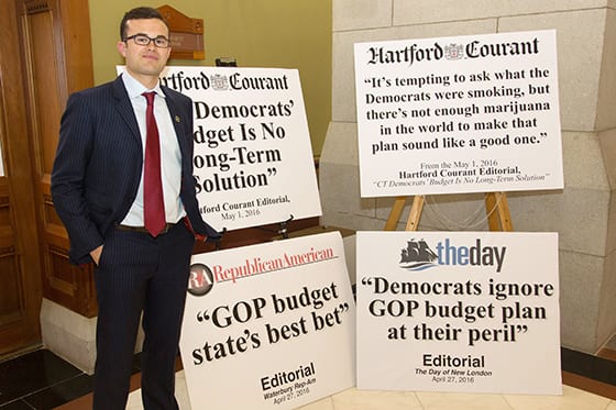 State Senator Art Linares poses outside of the CT Senate Republican caucus room with posters heralding the proposed republican state budget. CT State Capitol May 2, 2016.
