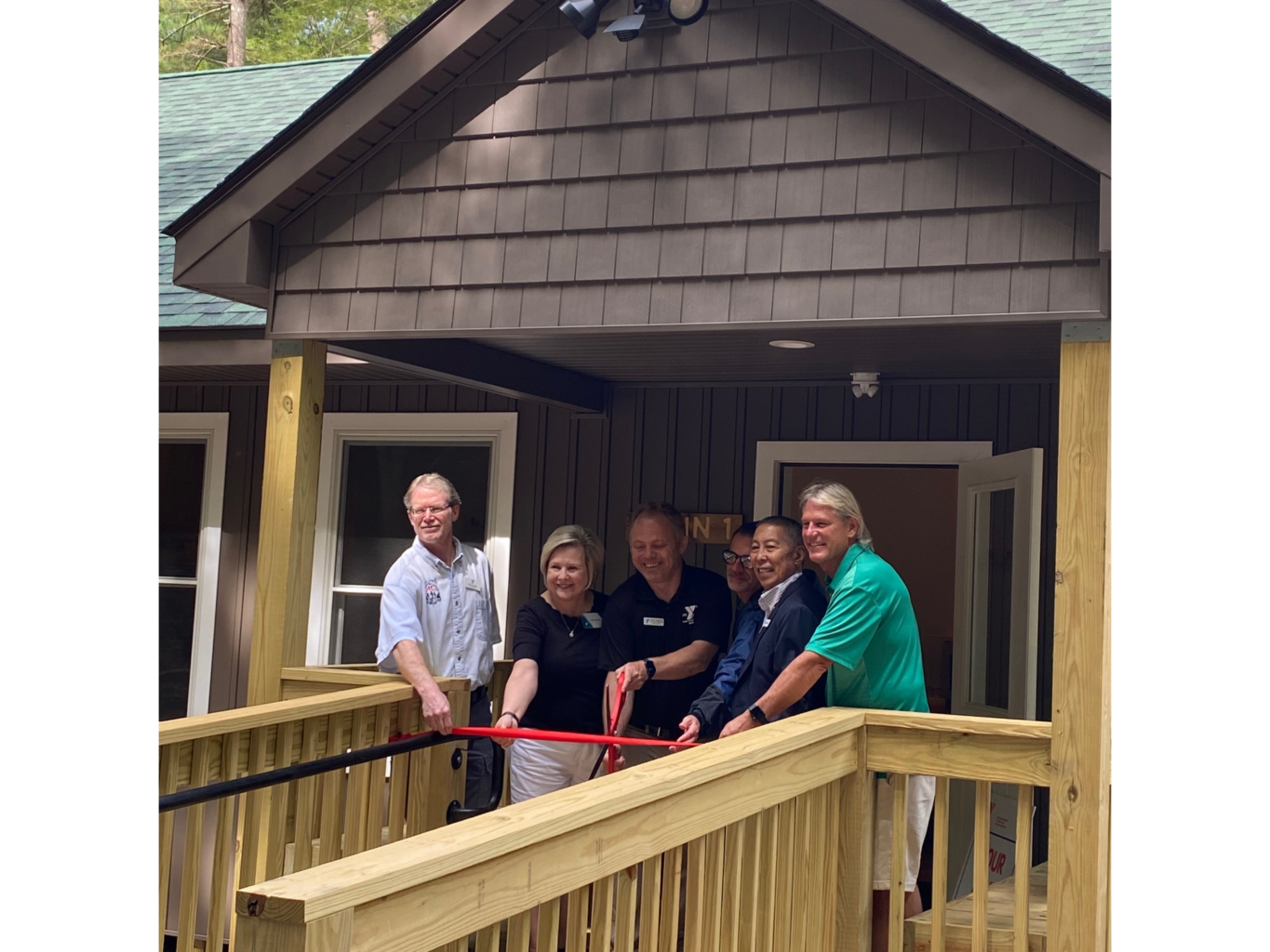 Senator Witkos (r) joins YMCA staff in cutting the ribbon on a brand new cabin for campers.